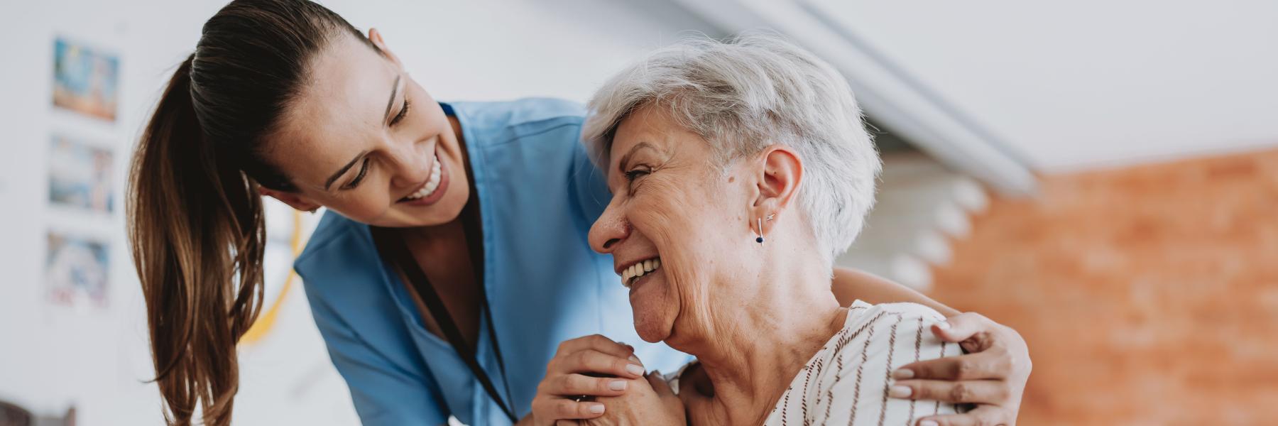 Home care healthcare professional hugging senior patient